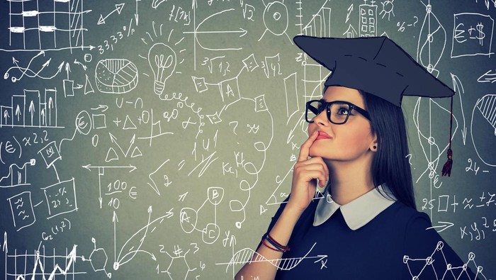 Young smart woman in cap exploring formulas and science looking confident and excited.
