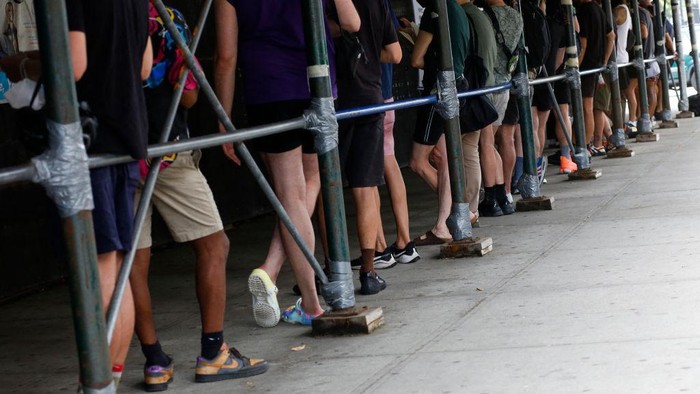 People wait in line to recieve the Monkeypox vaccine before the opening of a new mass vaccination site at the Bushwick Education Campus in Brooklyn on July 17, 2022, in New York City. - New York, on the US East Coast, has already either administered or scheduled 21,500 vaccines and hopes to speed up the process, promising more than 30,000 jabs for the whole state. (Photo by Kena Betancur / AFP) (Photo by KENA BETANCUR/AFP via Getty Images)