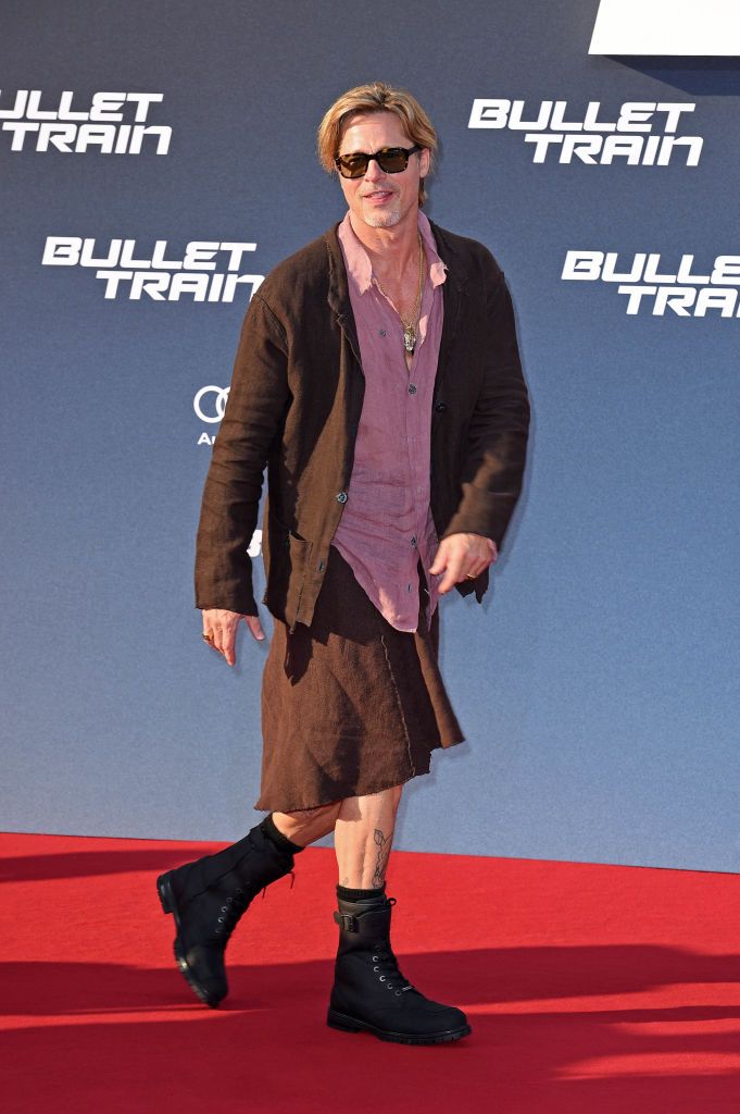 19 July 2022, Berlin: Brad Pitt, actor, wears a skirt as he arrives at the German premiere of the motion picture 