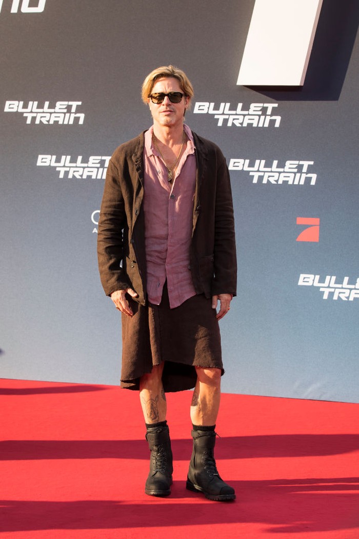 19 July 2022, Berlin: Brad Pitt, actor, wears a skirt as he arrives at the German premiere of the motion picture 