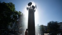 Gelombang panas di Jerman membuat suhu naik sampai 39 derajat celcius. Di Kota Cologne, warga terlihat main basah-basahan di bawah air mancur. (Getty Images)