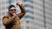 Pemimpin aksi berorasi menggunakan pengeras suara di hadapan pegawai Perhutani.
