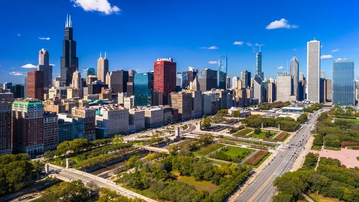 Downtown Chicago Skyline Aerial with a deep blue sky in the background and Grant Park in the foreground.