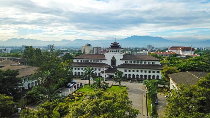 Aerial view of Gedung Sate, Bandung, West Java, Indonesia with beautiful sky and city landscape. Old Historical building with art decoration style, Governor Office