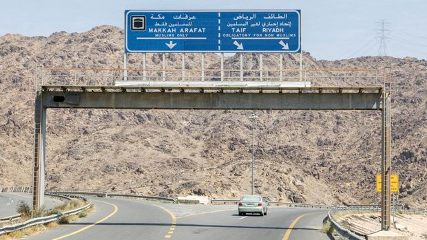 Makkah, Saudi Arabia, February 22 2020: Road sign in the vicinity of Mecca that non Muslims do have to drive around the holy city Mecca in Saudi Arabia