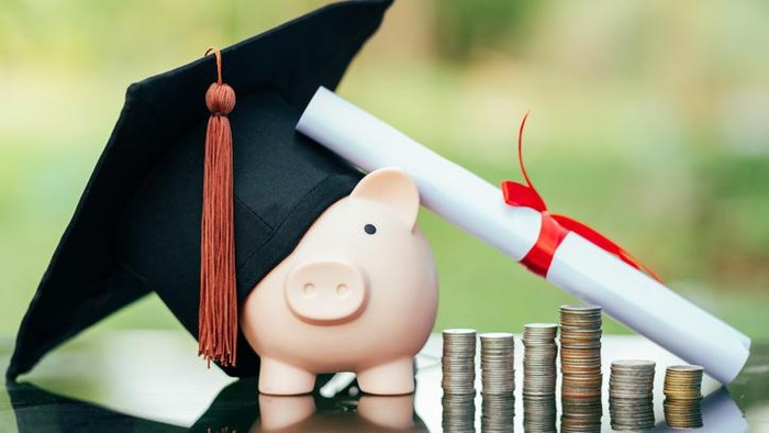 piggy bank With Graduation Cap on black glass floor,Money saving concept.