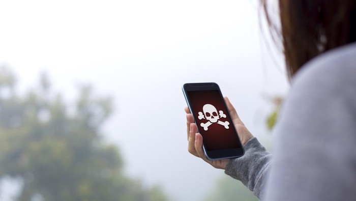 Young woman holding hacked smartphone.