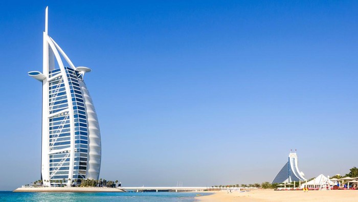 Dubai, United Arab Emirates - January 08, 2012: View of Burj Al Arab hotel from the Jumeirah beach. Burj Al Arab is one of the Dubai landmark, and one of the worlds most luxurious hotels with 7 stars.