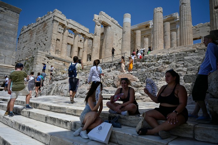 Turis di Acropolis, Athena kepanasan saat suhu udara mencapai 42 derajat celsius pada 24 Juli 2022. (Louisa Goulimaki/AFP via Getty Images)