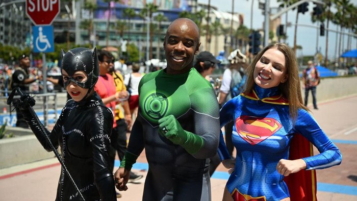 TOPSHOT - A cosplayer wearing a Top Gun jacket and a lego head walks outside the convention center during Comic-Con International 2022 on July 22, 2022 in San Diego, California. (Photo by Robyn Beck / AFP) (Photo by ROBYN BECK/AFP via Getty Images)
