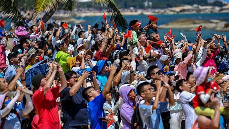WENCHANG, CHINA - JULY 24: Spectators watch as a Long March-5B Y3 rocket carrying China's space station lab module Wentian blasts off from Wenchang Spacecraft Launch Site on July 24, 2022 in Wenchang, Hainan Province of China. (Photo by Luo Yunfei/China News Service via Getty Images)