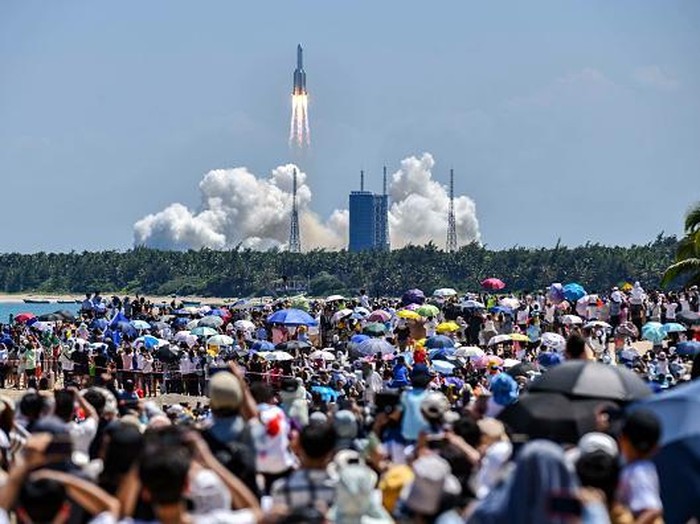 WENCHANG, CHINA - JULY 24: Spectators watch as a Long March-5B Y3 rocket carrying Chinas space station lab module Wentian blasts off from Wenchang Spacecraft Launch Site on July 24, 2022 in Wenchang, Hainan Province of China. (Photo by Luo Yunfei/China News Service via Getty Images)