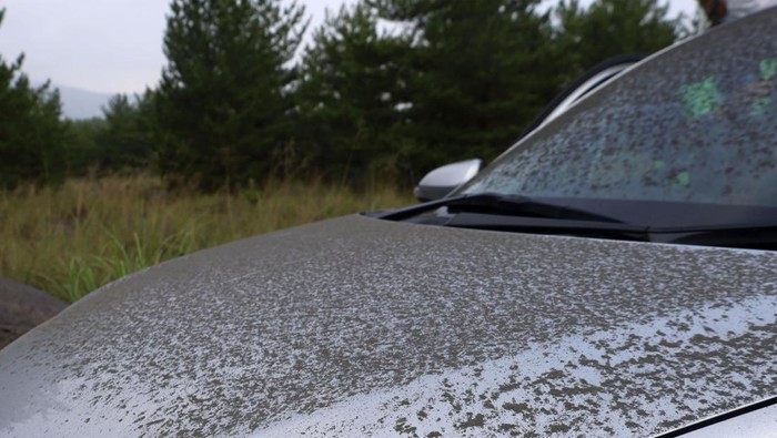 Ash from Sakurajima volcano is seen on a vehicle in Kagoshima, southern island of Kyushu, Japan Monday, July 25, 2022. The volcano erupted Sunday night, spewing ash and rocks, causing dozens of residents in nearby towns to evacuate to a safer part of the region. (Kyodo News via AP)