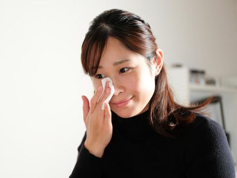 Young woman making up in the room