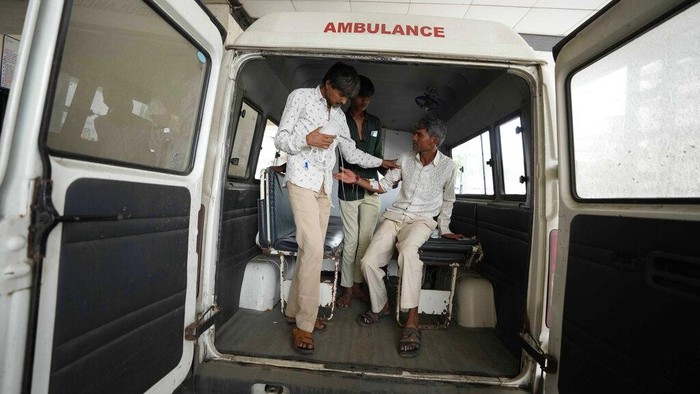 Vinodbhai Jadavbhai Solanki is carried for treatment to civil hospital after falling sick from consuming spurious liquor, in Ahmedabad, India, Tuesday, July 26, 2022. At least 21 people have died and another 30 fallen sick from drinking spurious liquor in Indias western state of Gujarat, officials said Tuesday. Senior government official Mukesh Parmar said the deaths occurred in Ahmedabad and Botad districts of the state, where manufacturing, sale and consumption of liquor are prohibited. (AP Photo/Ajit Solanki)