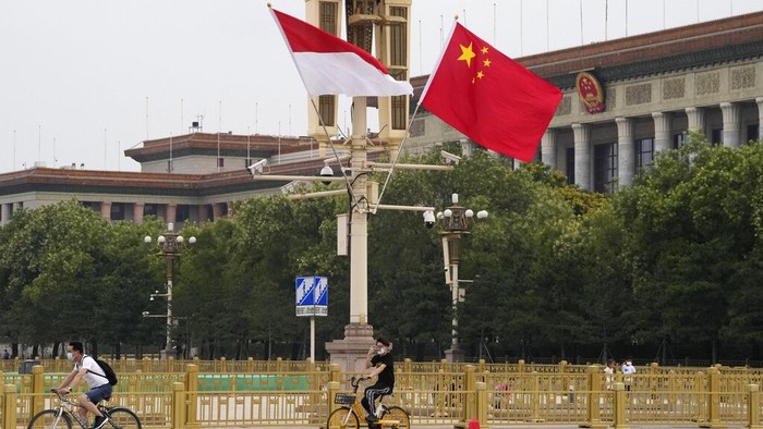 The Indonesian and Chinese national flags are flown together near the Great Hall of the People in Beijing, Monday, July 25, 2022. Indonesian President Joko Widodo was heading to Beijing on Monday for a rare visit by a foreign leader under China's strict COVID-19 protocols and ahead of what could be the first overseas trip by Chinese President Xi Jinping since the start of the pandemic more than two years ago. (AP Photo/Ng Han Guan)