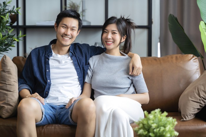 home isolation concept happiness asian love couple familygood conversation on sofa couch in living room ,marry couple laugh smile together on sofa
