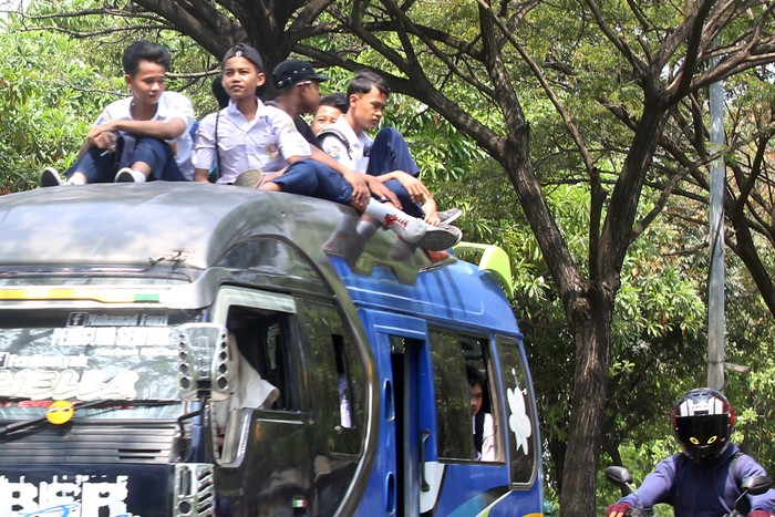 PELAJAR ABAIKAN KESELAMATAN Sejumlah pelajar sekolah menengah pertama (SMP) menumpang di atas atap mobil angkutan umum melintas di Jalan Marsekal Surya Dharma Neglasari, Tangerang, Banten, Selasa (26/7/2022). Aksi tersebut membahayakan keselamatan diri sendiri dan orang lain, serta dapat memicu tawuran antarpelajar yang kerap terjadi saat jam pulang sekolah. ANTARA FOTO/Muhammad Iqbal/rwa.