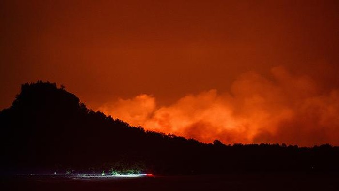 26 July 2022, Czech Republic, Hrensko: View of the forest fire in the Czech National Park Bohemian Switzerland in Hrensko near the border with Saxony. In the meantime, the fire is also spreading on the German side in the Saxon Switzerland National Park. Photo: Robert Michael/dpa (Photo by Robert Michael/picture alliance via Getty Images)