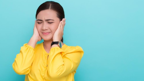 Asian woman close her ears