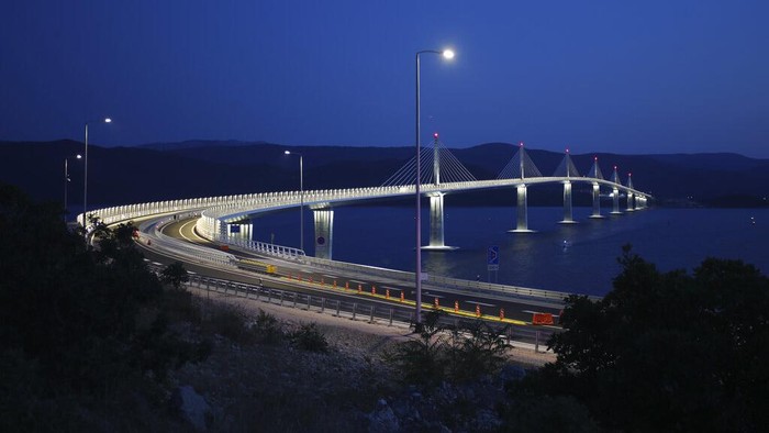 Fireworks illuminate skies over the newly built Peljesac Bridge in Komarna, southern Croatia, Tuesday, July 26, 2022. Croatia is marking the opening of a key and long-awaited bridge connecting two parts of the country's Adriatic Sea coastline while bypassing a small part of Bosnia's territory. (AP Photo)