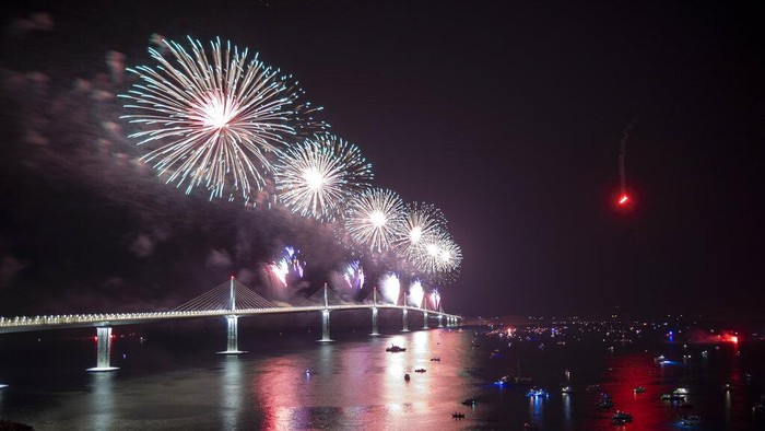 Fireworks illuminate skies over the newly built Peljesac Bridge in Komarna, southern Croatia, Tuesday, July 26, 2022. Croatia is marking the opening of a key and long-awaited bridge connecting two parts of the country's Adriatic Sea coastline while bypassing a small part of Bosnia's territory. (AP Photo)