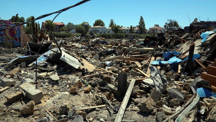 A local resident walks among remains of residential buildings destroyed by a Russian missile strike, as Russia's attack on Ukraine continue, in the settlement of Zatoka, Odesa region, Ukraine July 26, 2022.  REUTERS/Igor Tkachenko