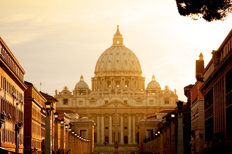 Vatican City, Vatican City State - August 21, 2008: St. Peters Basilica at sunset from Via della Conciliazione. Vatican City State. Rome, Italy.