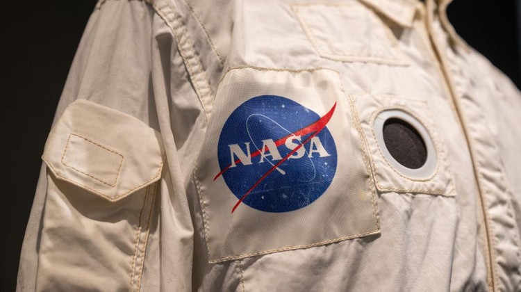 NEW YORK, NEW YORK - JULY 21: A woman takes a photo of Buzz Aldrins Inflight Coverall Jacket during the Apollo 11 mission is on display during a press preview at Sothebys on July 21, 2022 in New York City. Buzz Aldrins inflight jacket along with other pieces from his collection will be auctioned on July 26, 2022. (Photo by Alexi Rosenfeld/Getty Images)