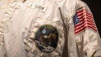 NEW YORK, NEW YORK - JULY 21: A woman takes a photo of Buzz Aldrins Inflight Coverall Jacket during the Apollo 11 mission is on display during a press preview at Sothebys on July 21, 2022 in New York City. Buzz Aldrins inflight jacket along with other pieces from his collection will be auctioned on July 26, 2022. (Photo by Alexi Rosenfeld/Getty Images)