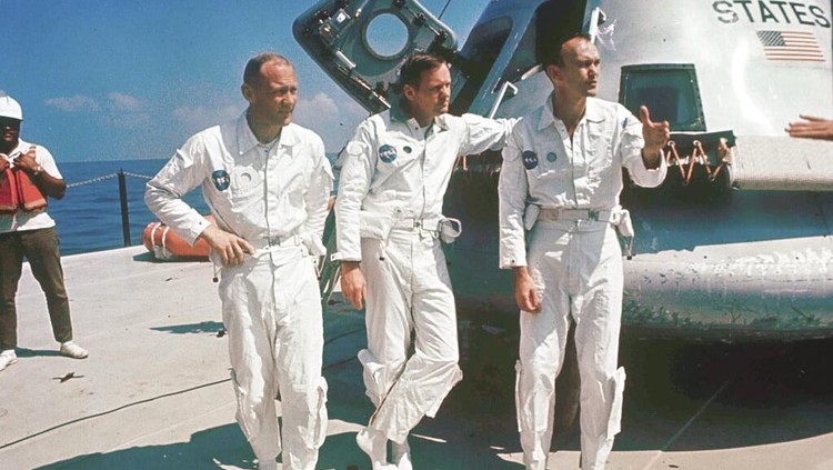 FILE - Apollo 11 astronauts Col. Edwin E. Aldrin, left, lunar module pilot, Neil Armstrong, center, flight commander, and Lt. Michael Collins, right, command module pilot, stand next to their spacecraft in 1969. A jacket worn by Aldrin on the historic first mission to the moons surface in 1969, sold for nearly $2.8 million at auction. (AP Photo/File)