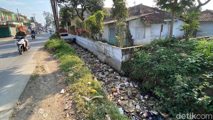 Kondisi drainase penuh sampah di Jalan Raya Majalaya - Rancekek, Kabupaten Bandung