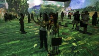 Para tamu dan jurnalis berdiri di pameran multimedia Van Gogh Live 8K yang menampilkan proyeksi lukisan seniman Belanda Vincent Willem van Gogh di Rio de Janeiro, Brasil, Rabu, (27/7/2022).