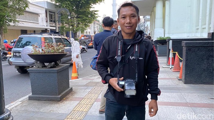 Mustaqim, fotografer di Jalan Asia Afrika, Kota Bandung.