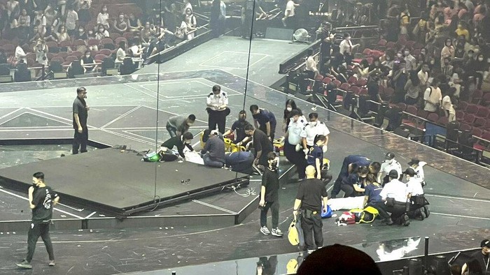 CORRECTS DATE - In this image made from video taken from social media, a massive video screen suspended above the stage fells onto performers at a concert of Cantopop boy band Mirror, in Hong Kong, Thursday, July 28, 2022. Two dancers were injured at a Cantopop concert in Hong Kong after a massive video screen suspended above the stage fell onto performers below. (AP Photo)