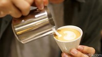 Barista sedang meracik kopi pesanan pelanggan.