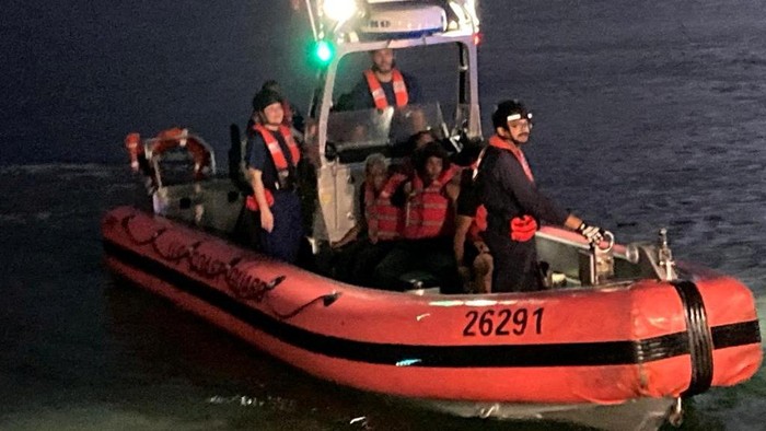 Migrants, who survived a human smuggling event in which migrants were forced to get out of a makeshift wooden boat, arrive in Puerto Rico, July 28, 2022. REUTERS/Ricardo Ortiz NO RESALES. NO ARCHIVES.