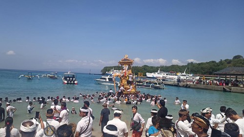 Prosesi ngaben di Desa Adat Padangbai unik. Saat bade diarak menuju setra atau kuburan setempat, ratusan warga harus melewati jalur laut sekitar 200 meter.