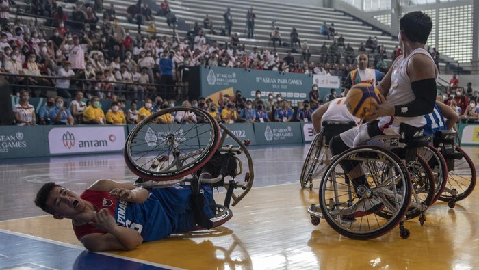 BASKET KURSI RODA INDONESIA MELAWAN FILIPINA Pebasket Indonesia Kasep Ayatulloh (kiri) mencoba menghalau bola yang dikuasai pebasket Filipina pada pertandingan pertama basket kursi roda ASEAN Para Games 2022 di GOR Sritex Arena, Solo, Jawa Tengah, Sabtu( 30/7/2022). Indonesia kalah dengan skor 10-15. ANTARA FOTO/Muhammad Adimaja/tom.