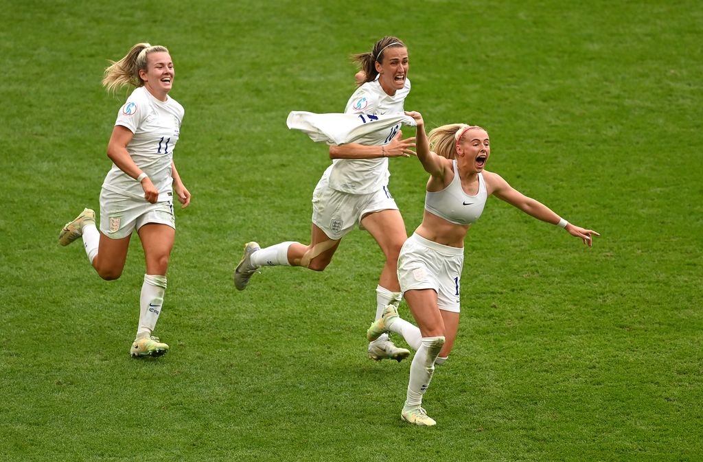 LONDON, ENGLAND - JULY 31: Chloe Kelly of England celebrates scoring their side's second goal with teammates Lauren Hemp and Jill Scott during the UEFA Women's Euro 2022 final match between England and Germany at Wembley Stadium on July 31, 2022 in London, England. (Photo by Michael Regan/Getty Images)