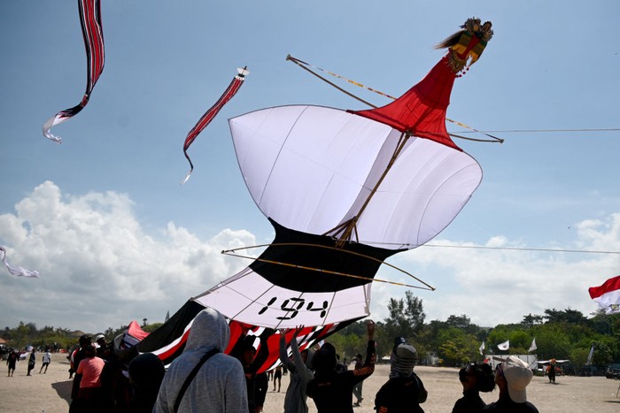 People fly their kites during the Kite Festival at Mertasari beach in Sanur on the Indonesian resort island of Bali on July 31, 2022. (Photo by SONNY TUMBELAKA / AFP) (Photo by SONNY TUMBELAKA/AFP via Getty Images)