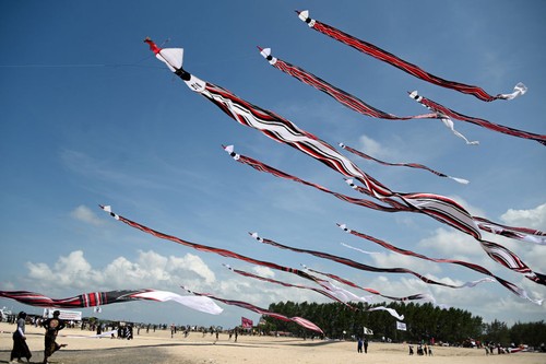 People fly their kites during the Kite Festival at Mertasari beach in Sanur on the Indonesian resort island of Bali on July 31, 2022. (Photo by SONNY TUMBELAKA / AFP) (Photo by SONNY TUMBELAKA/AFP via Getty Images)