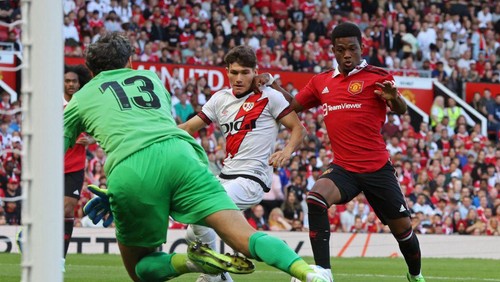 Manchester Uniteds Ivorian midfielder Amad Diallo (R) prepares to shoot, as he scores the opening goal of the pre-season club friendly football match between Manchester United and Rayo Vallecano at Old Trafford in Manchester, north west England, on July 31, 2022. (Photo by Nigel Roddis / AFP) (Photo by NIGEL RODDIS/AFP via Getty Images)