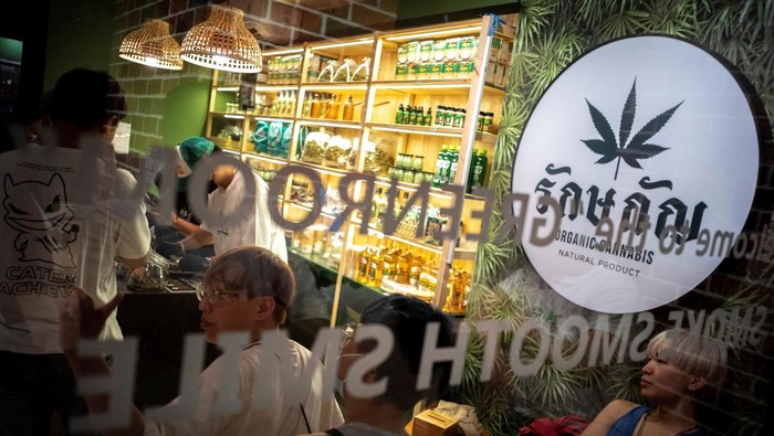 Tourists shop cannabis at the RG420 cannabis store, at Khaosan Road, one of the favourite tourist spots in Bangkok, Thailand, July 31, 2022. REUTERS/Athit Perawongmetha