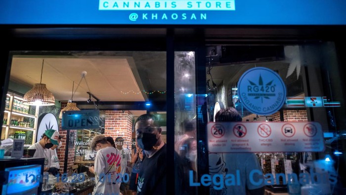 Tourists shop cannabis at the RG420 cannabis store, at Khaosan Road, one of the favourite tourist spots in Bangkok, Thailand, July 31, 2022. REUTERS/Athit Perawongmetha