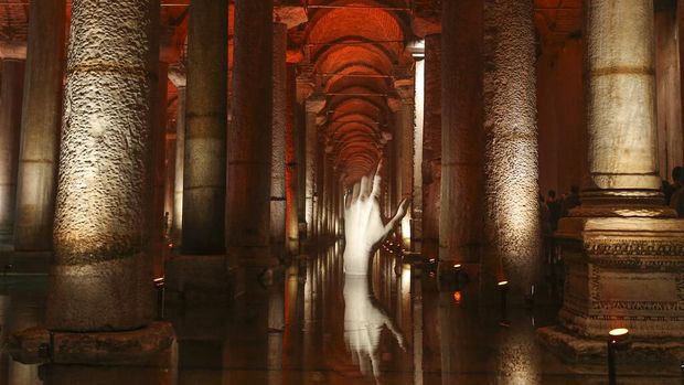 A hand shape sculpture is reflected in the water at the Byzantine-era Basilica Cistern in Istanbul, Turkey, Wednesday, July 27, 2022. The historical cistern, which is the biggest in Istanbul, was built in the 6th century during the reign of Byzantine Emperor Justinian I. (AP Photo/Emrah Gurel)