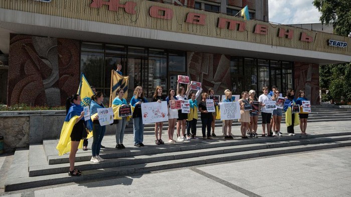 1242248204 ZHYTOMYR, UKRAINE - AUGUST 01: People shout slogans and hold banners during a rally in support of Azov Battalion Members on August 1, 2022 in Zhytomyr, Ukraine. Last Thursday, a facility holding Ukrainian PoWs in the town of Olenivka, in Russian-occupied Donetsk, was bombed, killing at least 50 people. The prisoners held there included members of the Azov battalion, who were captured at the Azovstal steel plant in Mariupol, however many family members say they can't confirm if their loved ones survived the bombing. Both Russia and Ukraine have blamed each other for the attack and the Red Cross have so far been denied access to the site. (Photo by Alexey Furman/Getty Images)