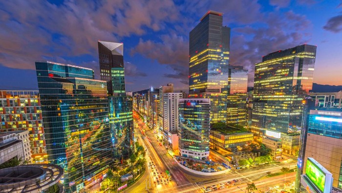 Beautiful sky and Traffic speeds through an intersection at night in Gangnam, Seoul in South Korea.Traffic.Fish eye view.