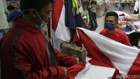 Para penjahit memeriksa kain dengan teliti dan detil. Mereka banjir pesanan bendera merah putih.