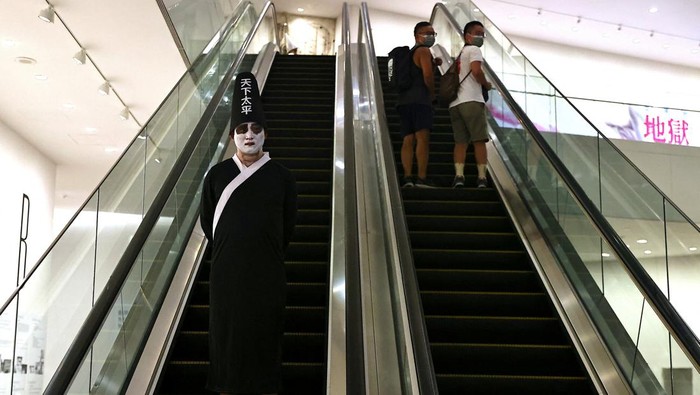 A visitor dressed as a ghost attends 